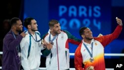 Олимпийский чемпион Лазизбек Муллажонов (второй слева) и другие призеры Игр в Париже на пьедестале