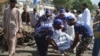 Pakistani rescue workers carry a body of a victim at the scene of a suicide bomb blast in Quetta, June 23, 2017