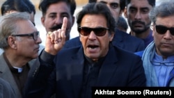 Imran Khan, chairman of the Pakistan Tehreek-e-Insaf (PTI) political party, gestures as he addresses members of the media, after Pakistan's Supreme Court dismissed a petition to disqualify him from parliament.