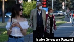Люди идут по улице во время вспышки коронавирусной болезни (COVID-19) в Алматы, Казахстан, 29 июня 2020 г. 