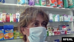 Armenia -- Employee of a drugstore in Yerevan wears a mask, Yerevan, 10Nov2009