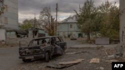 Пошкоджені автомобілі та будівлі в місті Курахове у Покровському районі на сході Донецької області, 8 жовтня 2024 року
